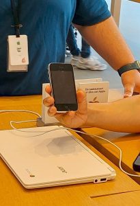 hand holding up old iphone at Apple Store