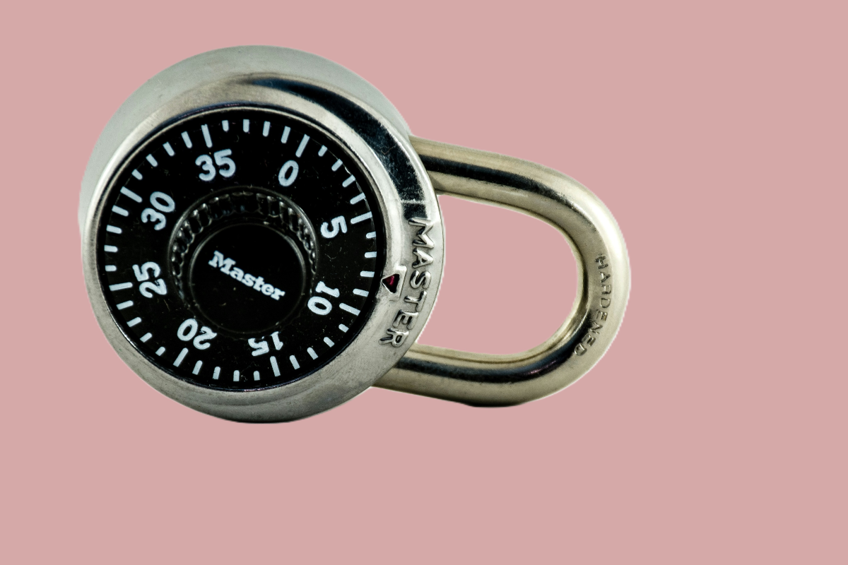 combination lock on pink bacground representing the daily friction of managing passwords